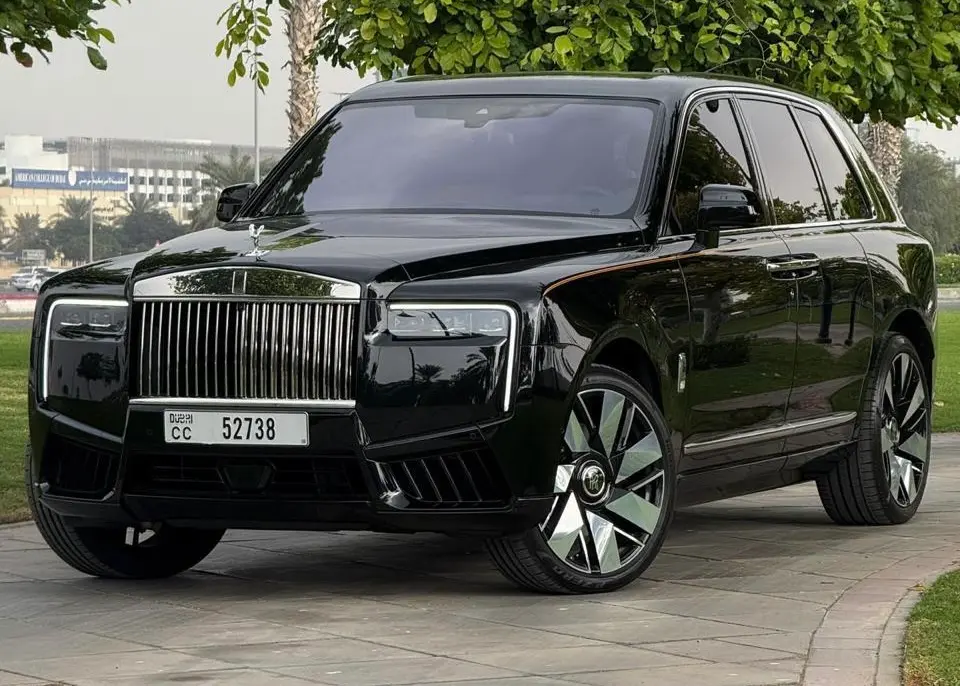 Black Rolls Royce Cullinan for rent in Dubai pictured on a bridge at sunset